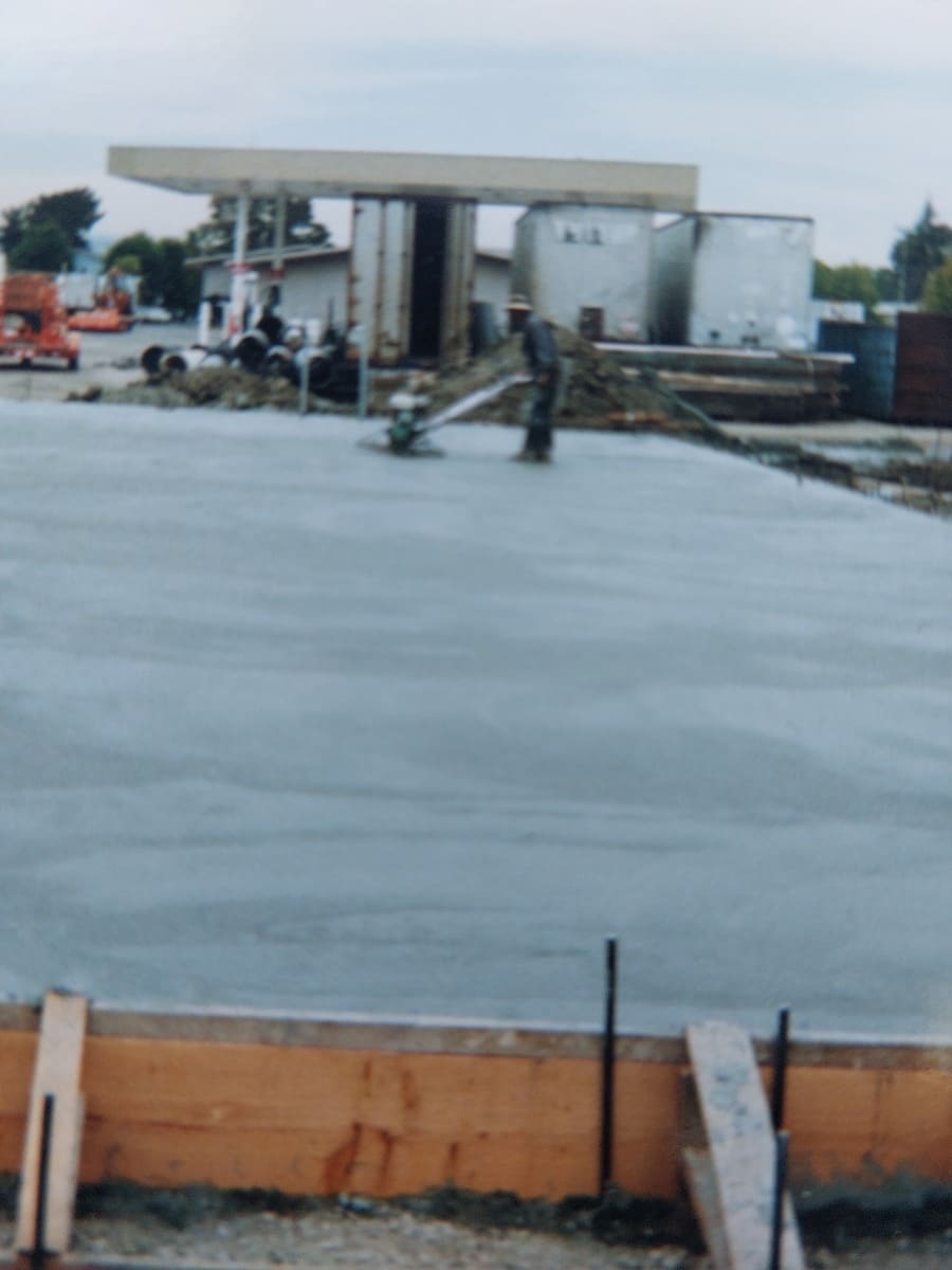 Concrete pump truck placing a large slab pour on a commercial site