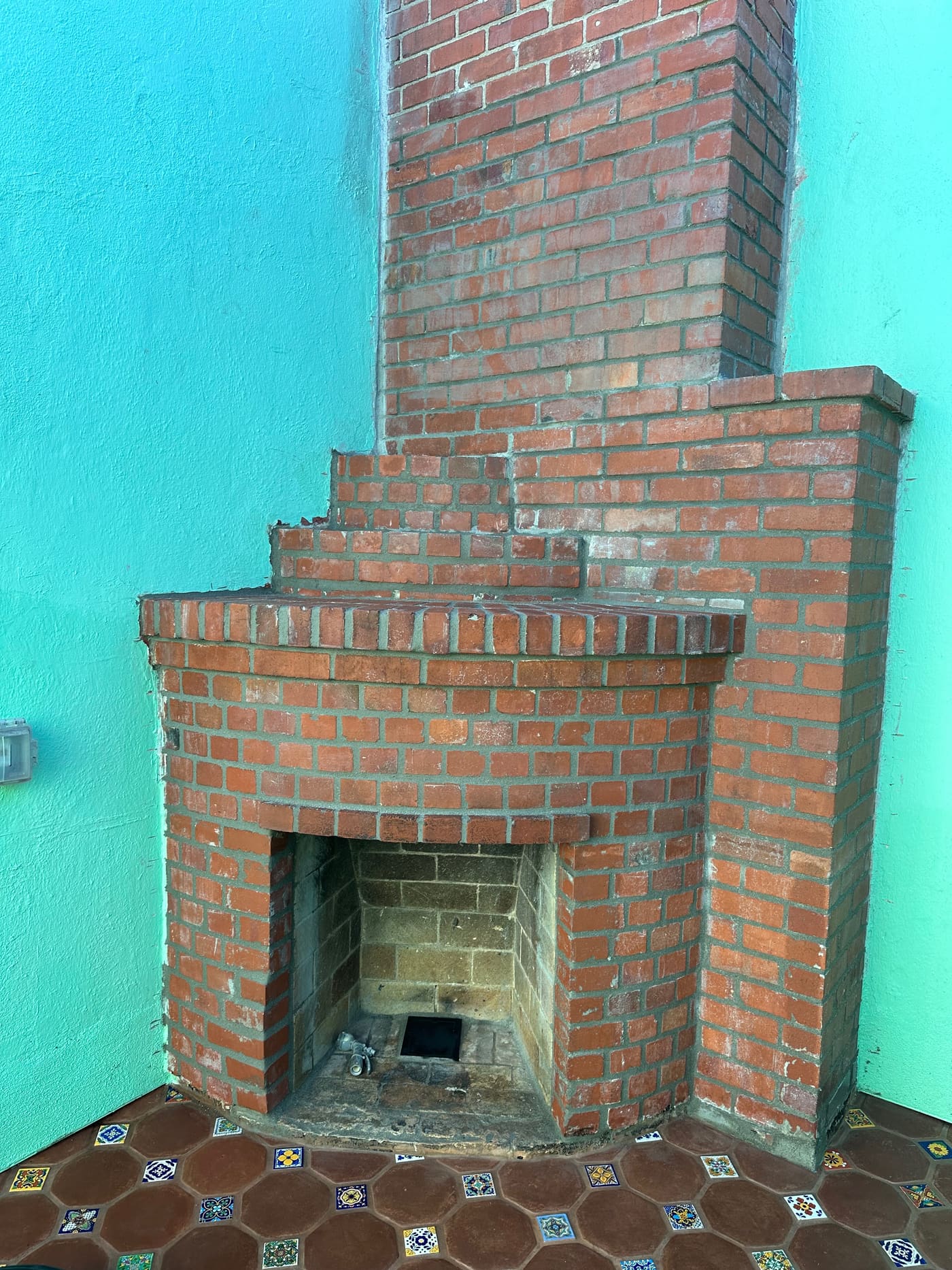 Rebuilt brick fireplace and chimney on an exterior wall