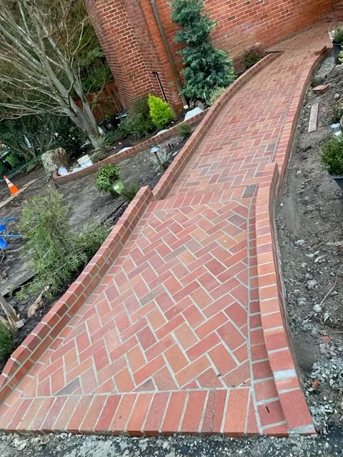 Curved brick walkway laid in a herringbone pattern