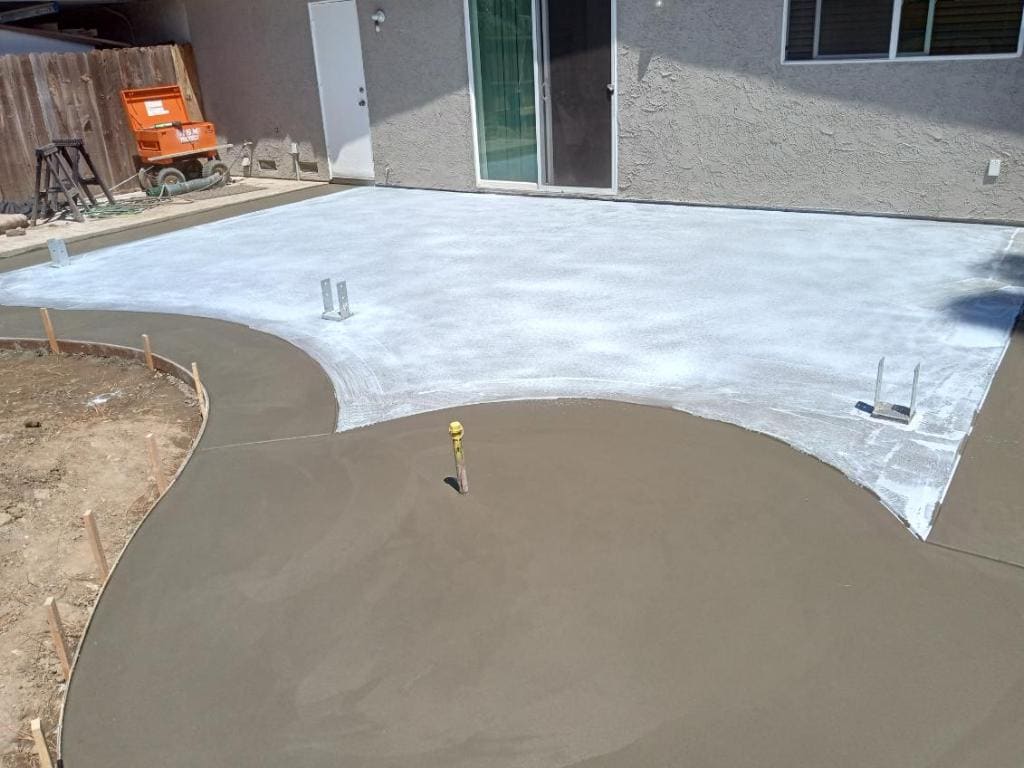 Freshly poured curved concrete patio slab