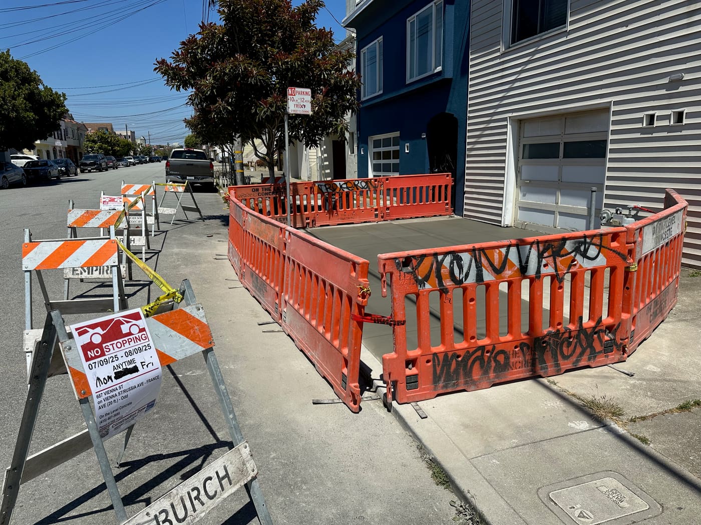 Sidewalk pour behind construction fencing on a city street