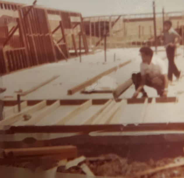 An old photo of Sean on a job site with his dad, early in his career